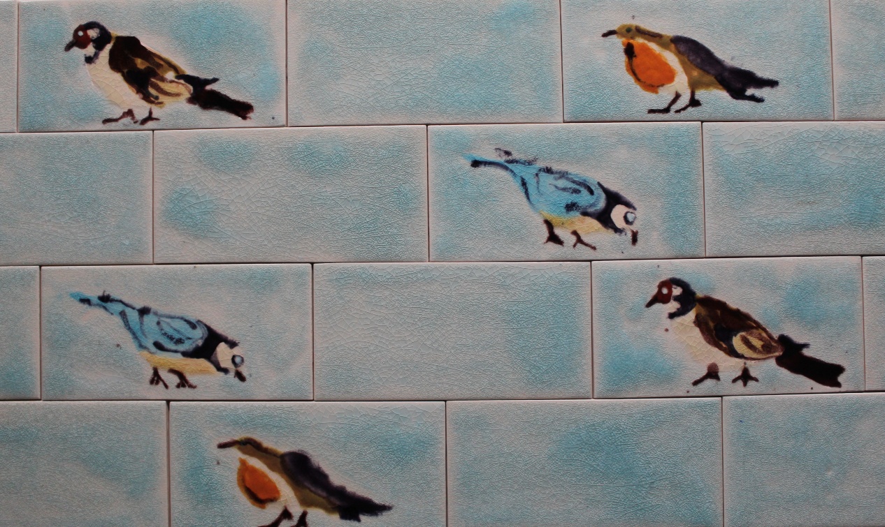 Handmade picture bird  tiles integrated into a tiled splashback